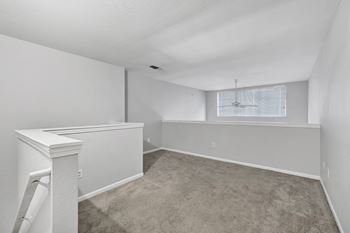 A room with white walls and a carpeted floor.